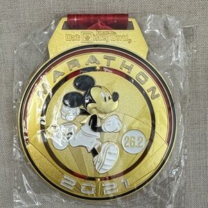 Rundisney Disney Gold Marathon Medal with Mickey Mouse and Red Ribbon